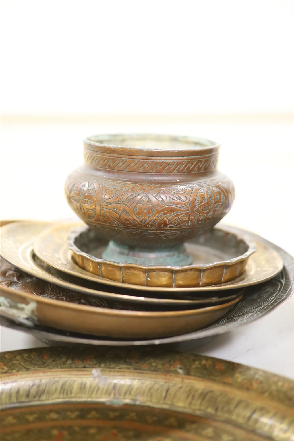 A group of Asian and copper trays, bowls etc